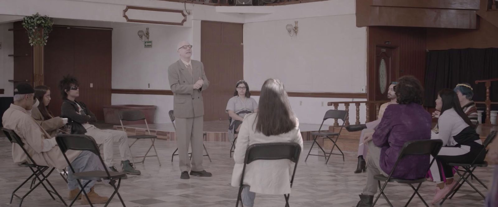 a group of people sitting in chairs in a room