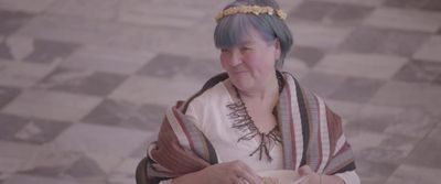 a woman with blue hair is holding a plate of food