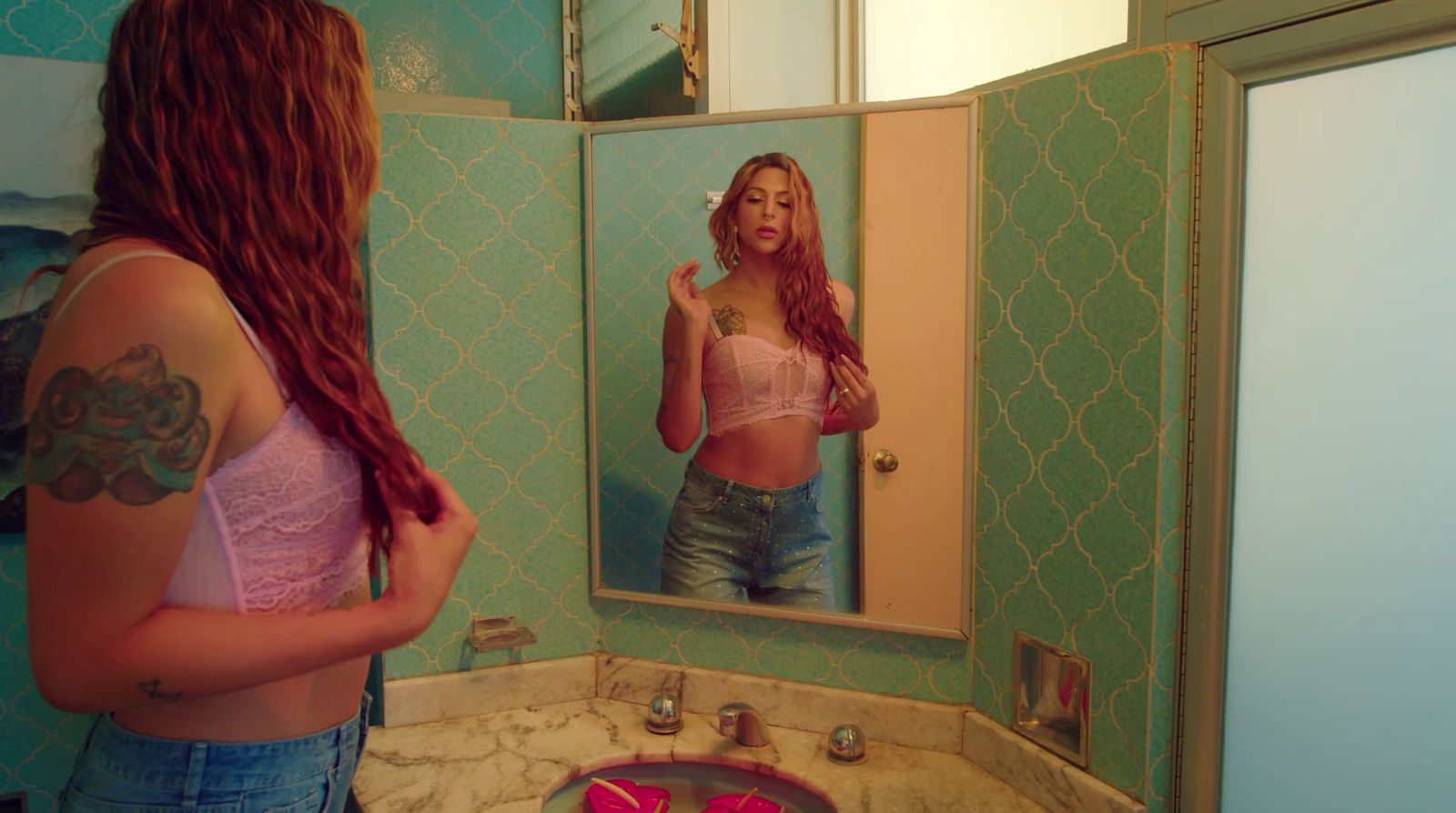 a woman brushing her teeth in front of a mirror