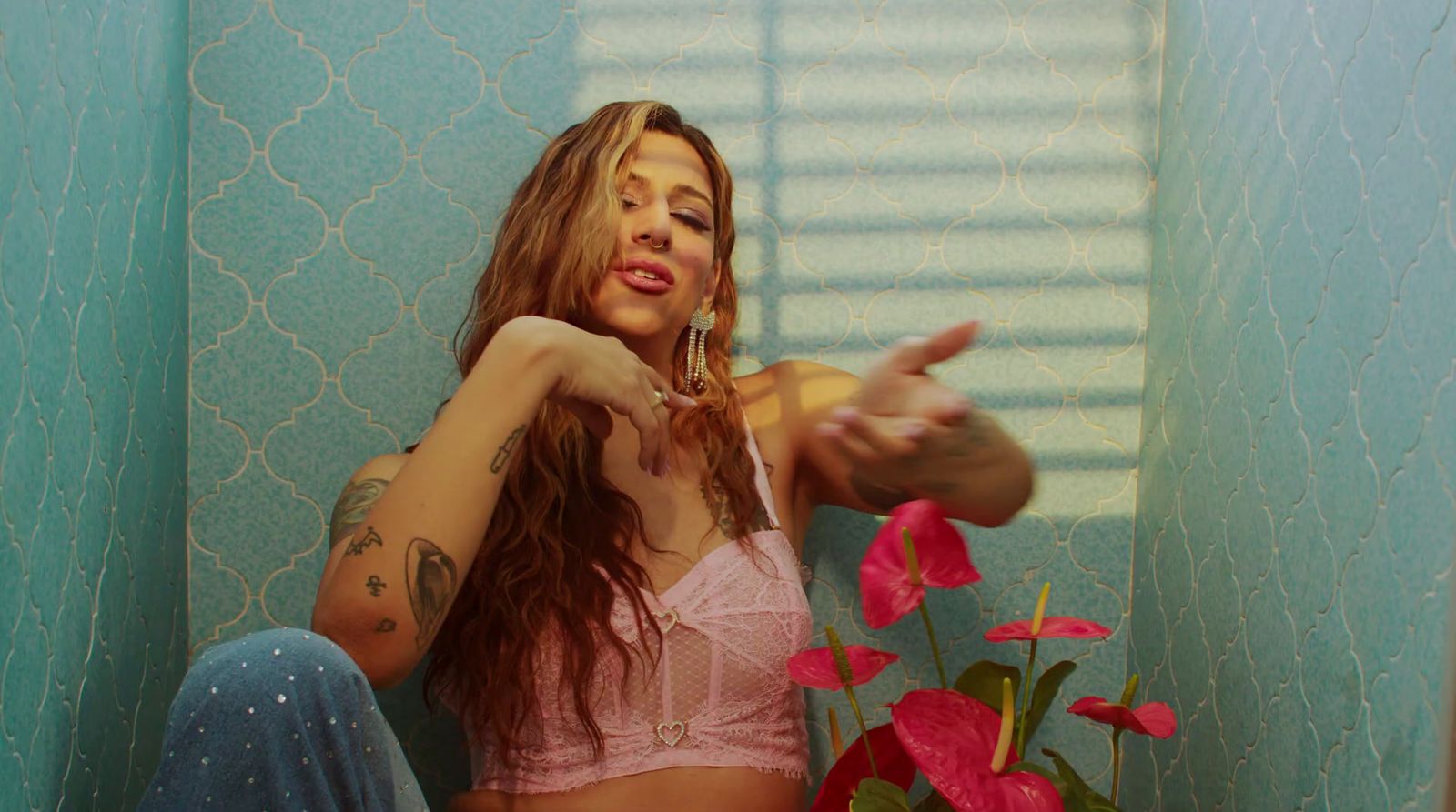 a woman in a pink bra top sitting on a toilet