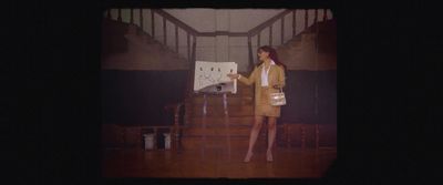 a woman standing in front of a white board