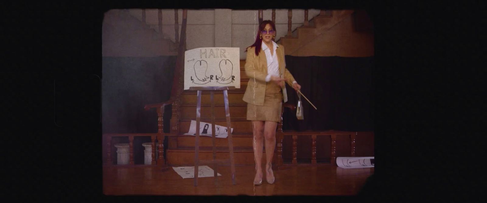 a woman standing on a stage holding a sign