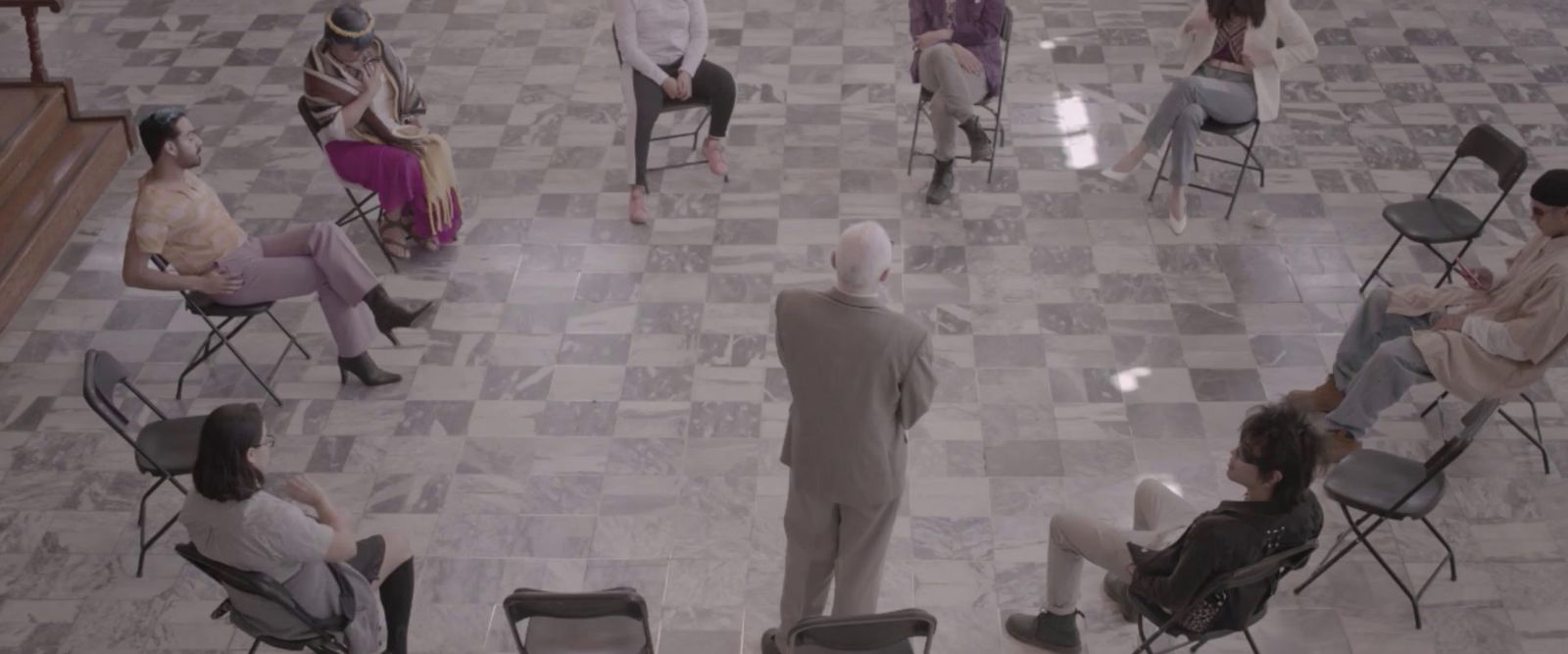 a group of people sitting in chairs in a room