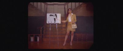 a woman standing in front of a white board