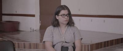 a woman sitting on a chair in a room