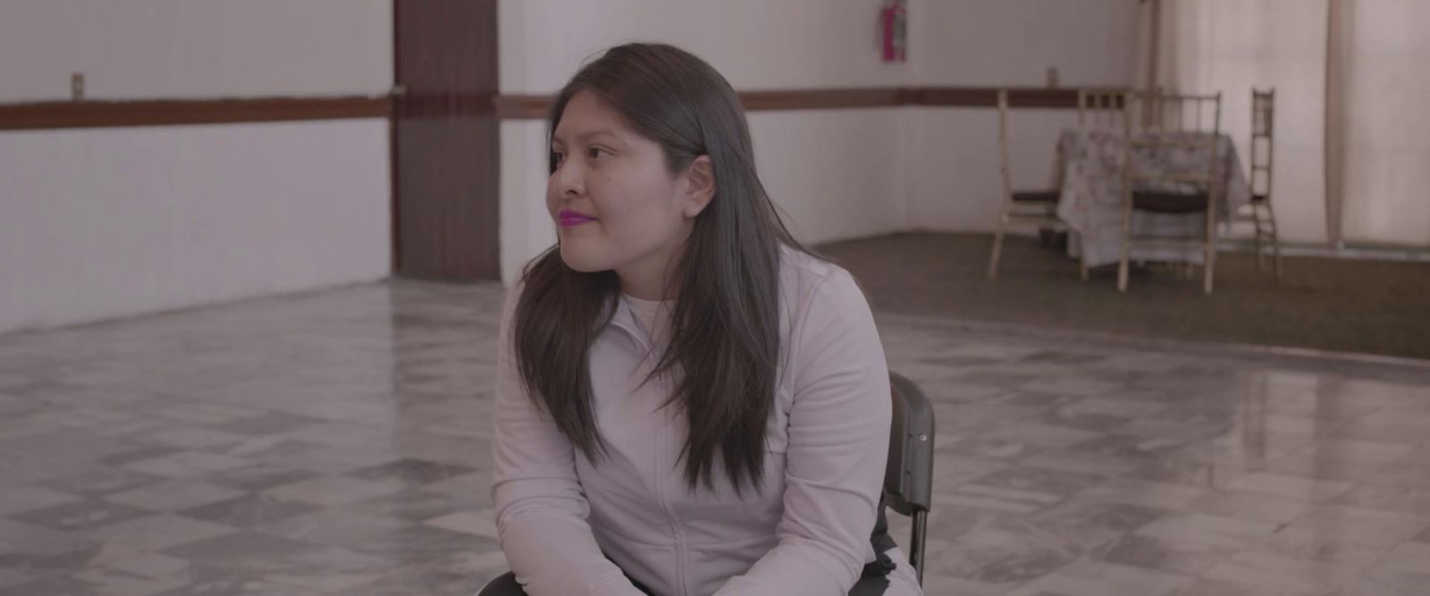 a woman sitting in a chair in a room