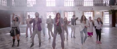 a group of people standing on top of a tiled floor