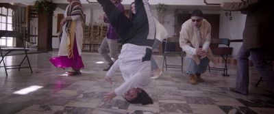 a person doing a handstand on a tiled floor