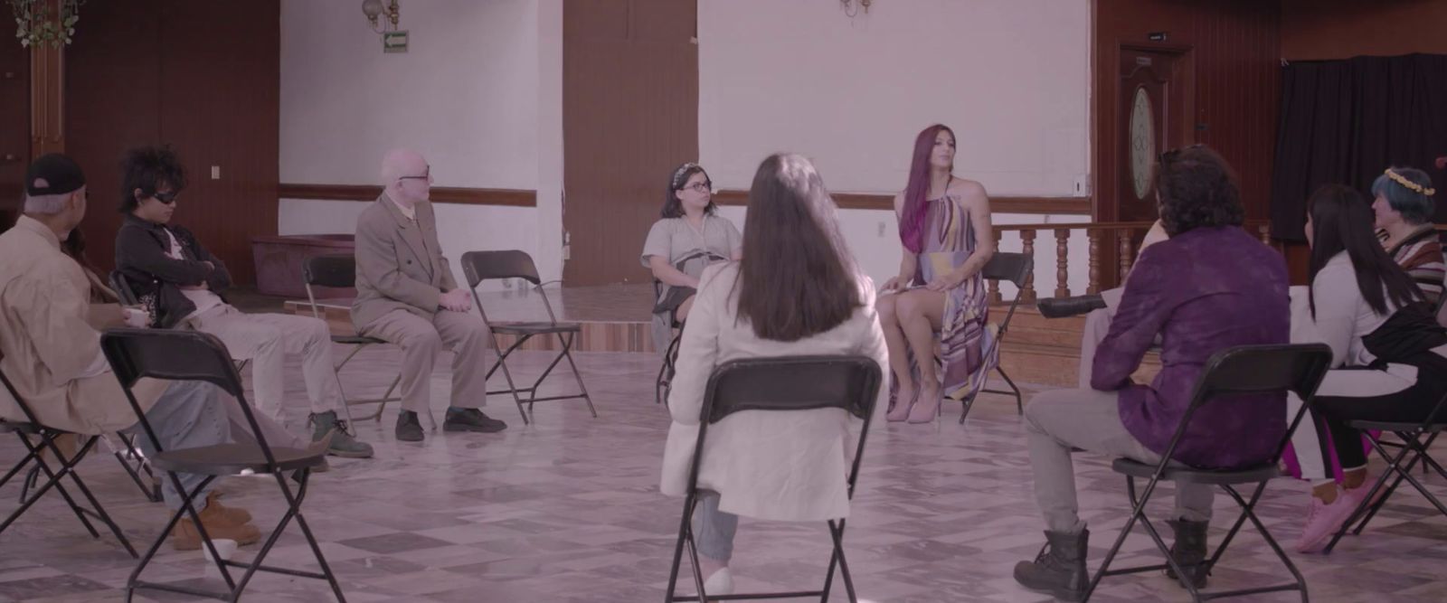 a group of people sitting in chairs in a room