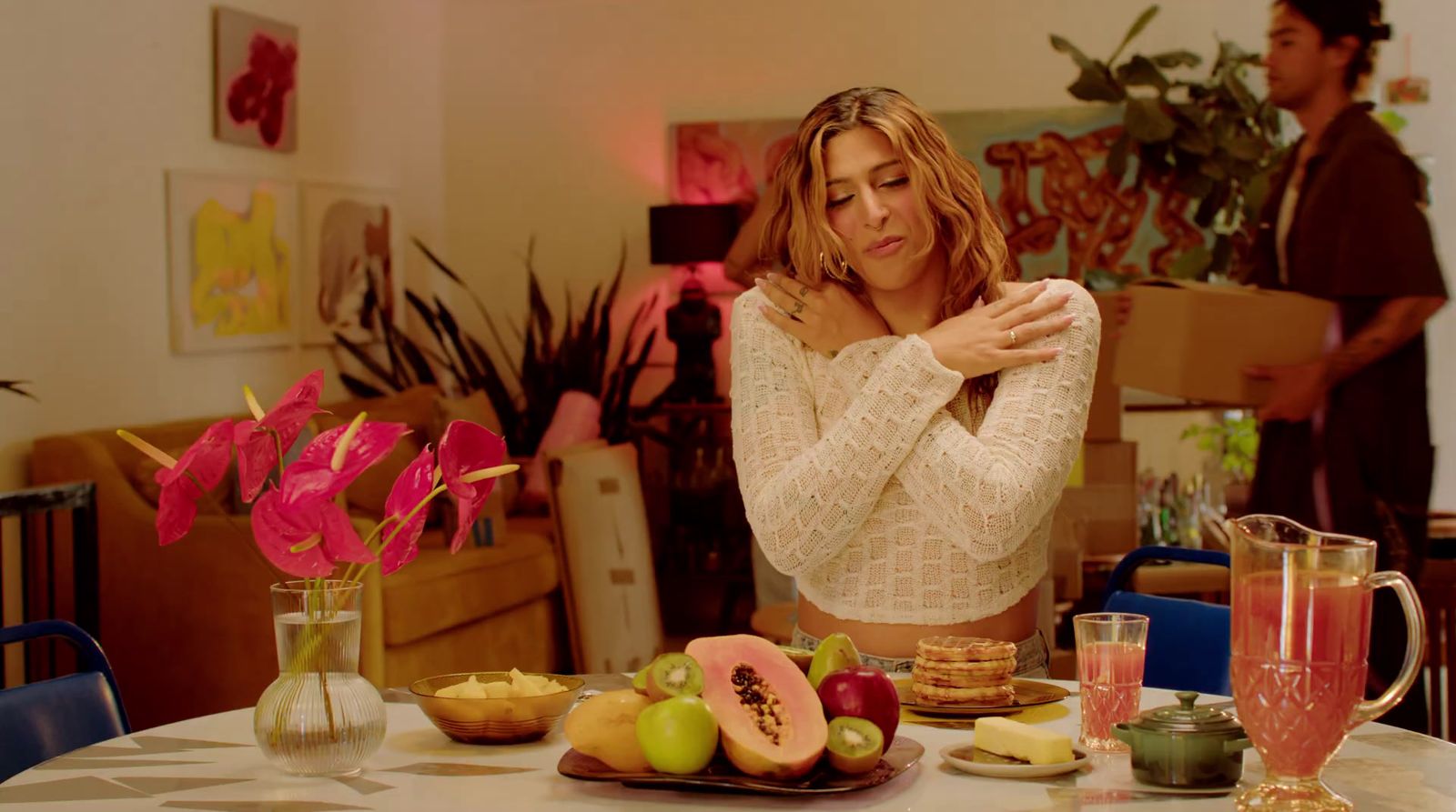 a woman standing in front of a table full of food