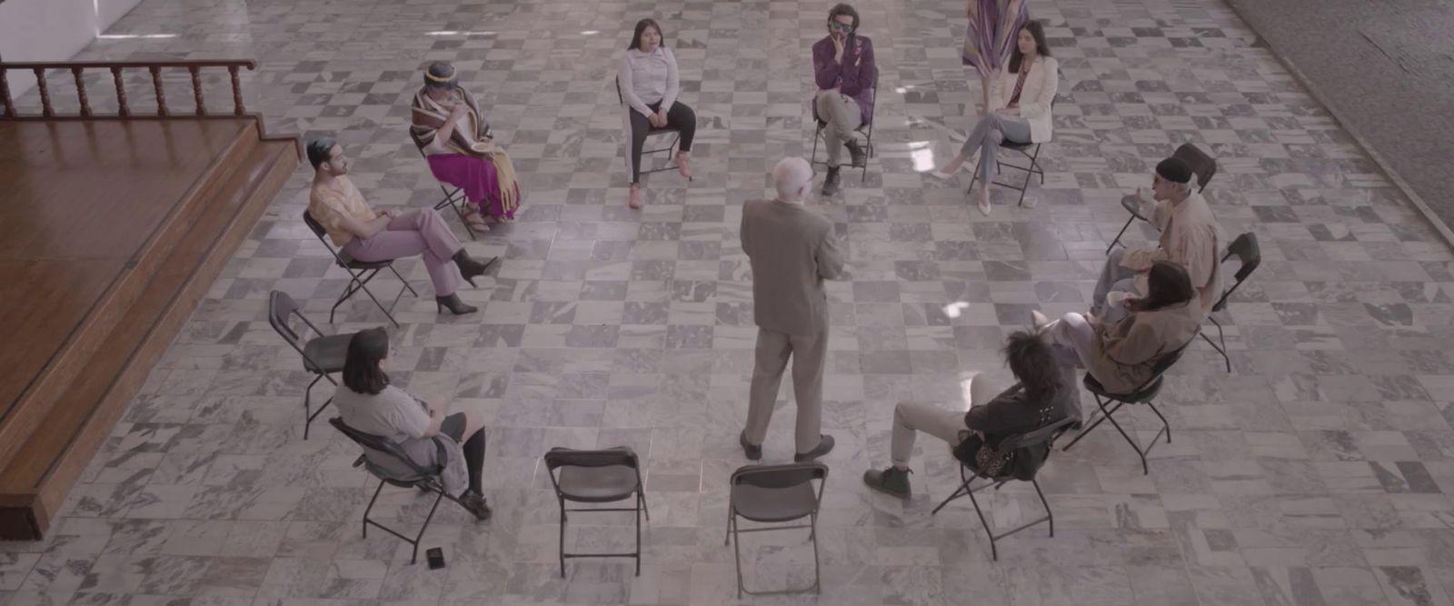 a group of people sitting in chairs in a room