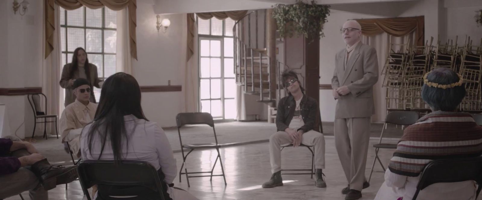 a group of people sitting in chairs in a room