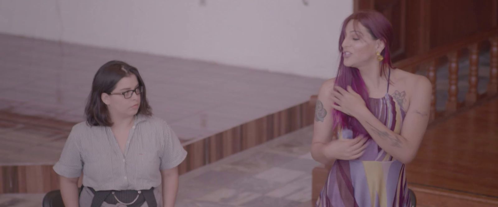 a woman standing next to a woman with purple hair