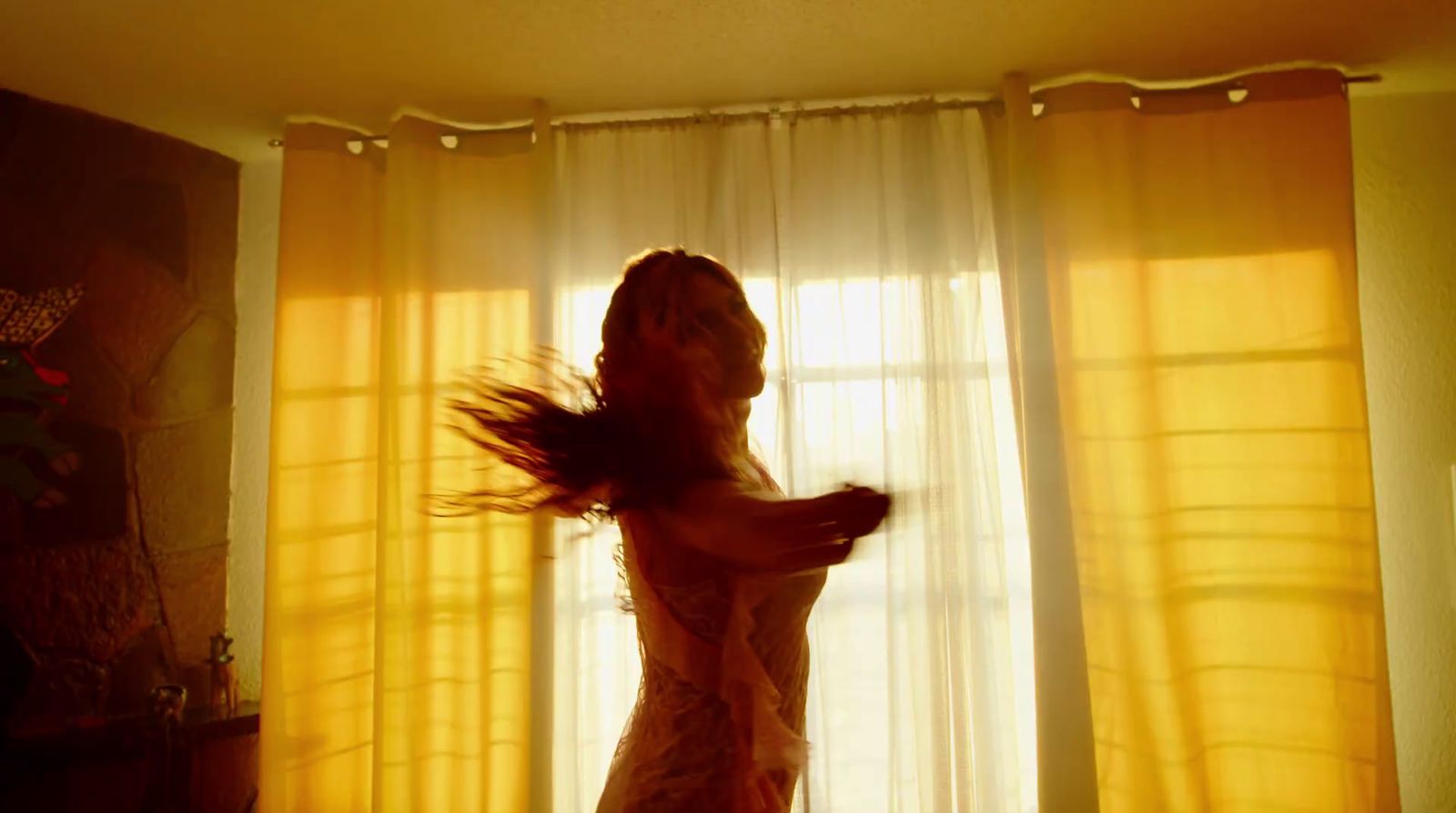 a woman standing in front of a window in a room