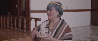 a woman with blue hair holding a plate of food