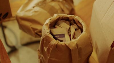 a brown bag sitting on top of a wooden table