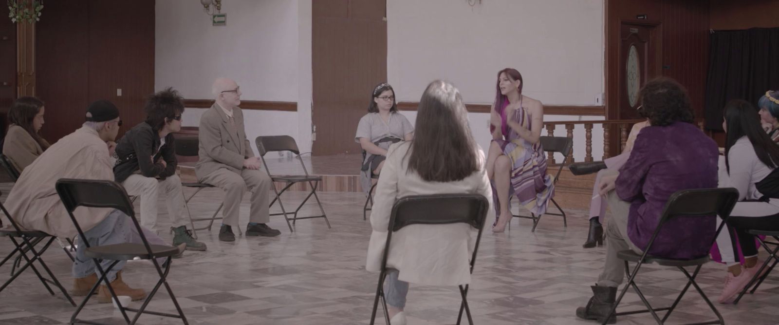 a group of people sitting in chairs in a room