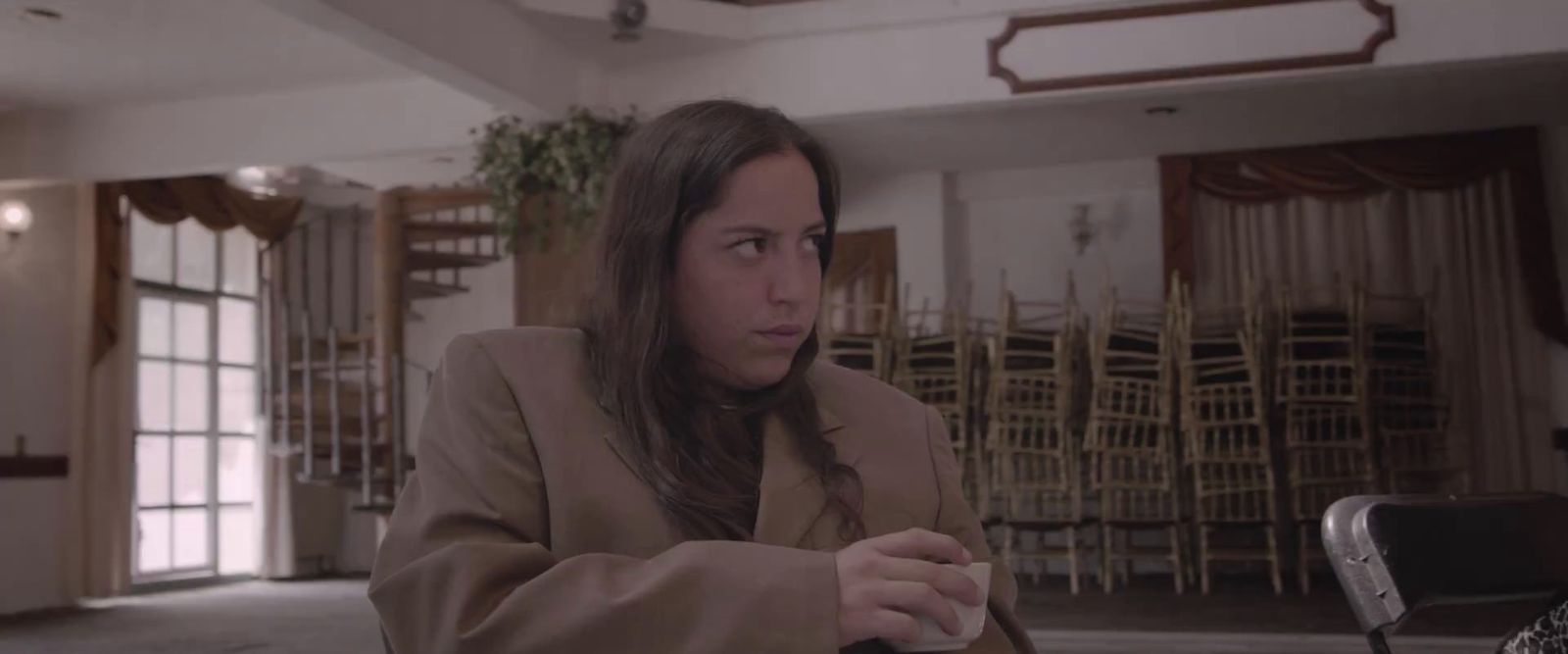 a woman sitting at a table with a knife and fork in her hand