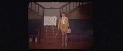 a woman standing in front of a whiteboard with writing on it