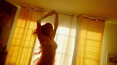 a woman standing in front of a window in a room