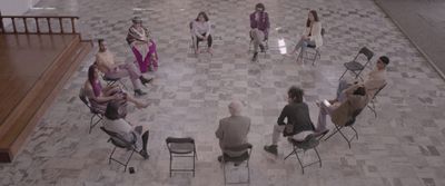 a group of people sitting in chairs in a room