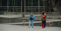 a couple of people standing in front of a building