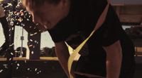 a man blowing out confetti on a cake