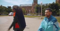 a man and a woman walking down a sidewalk