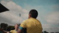 a man in a yellow shirt throwing a frisbee