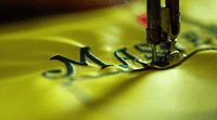 a close up of a sewing machine with a needle