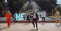 a group of people standing in front of a fountain