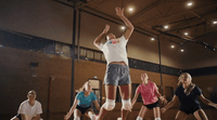 a group of people playing a game of basketball