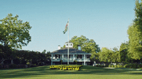 a white house with a flag on top of it