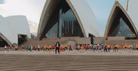 a large group of people standing in front of a building