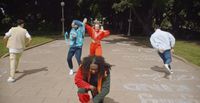 a group of young people playing a game of frisbee