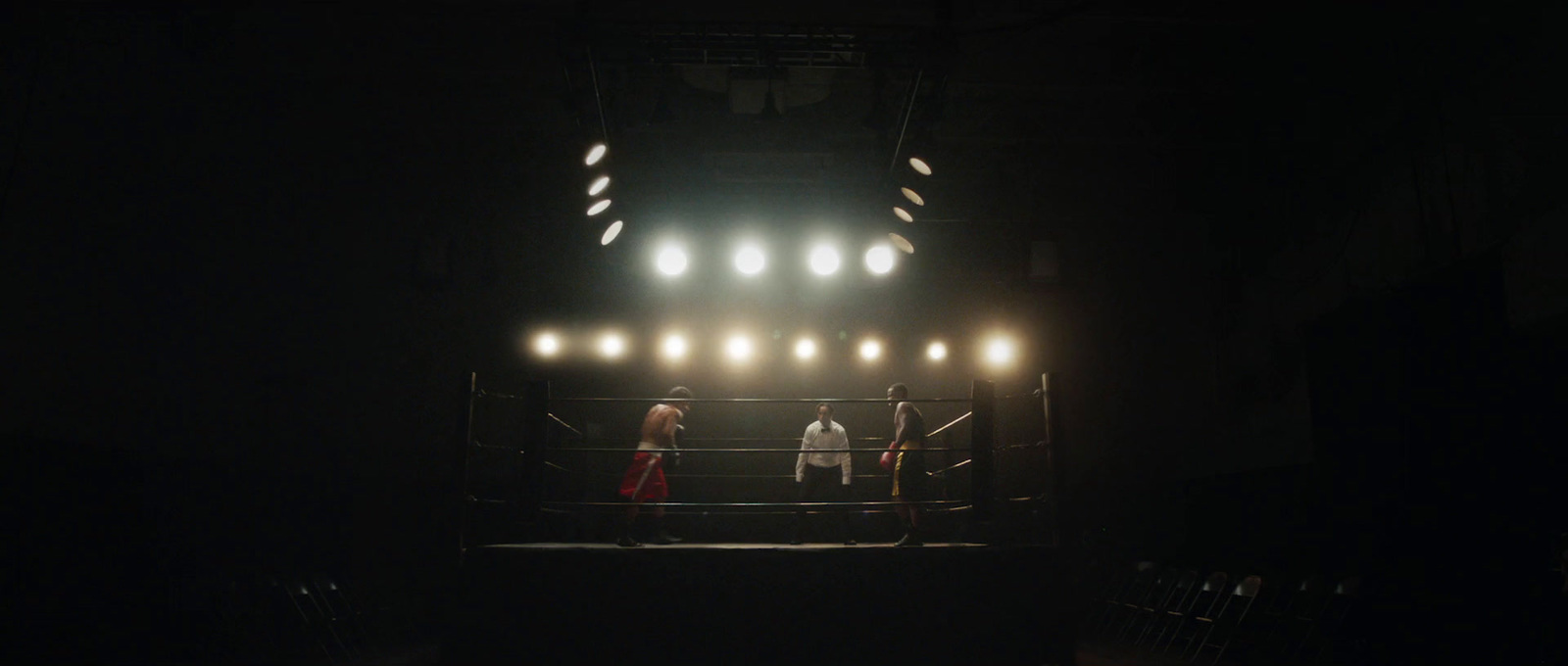 a group of people standing on top of a boxing ring