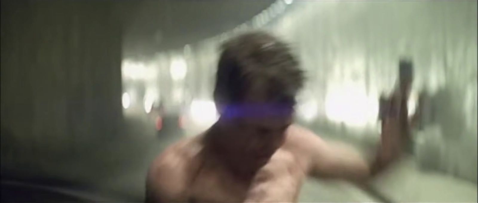 a blurry image of a shirtless man in a bathroom