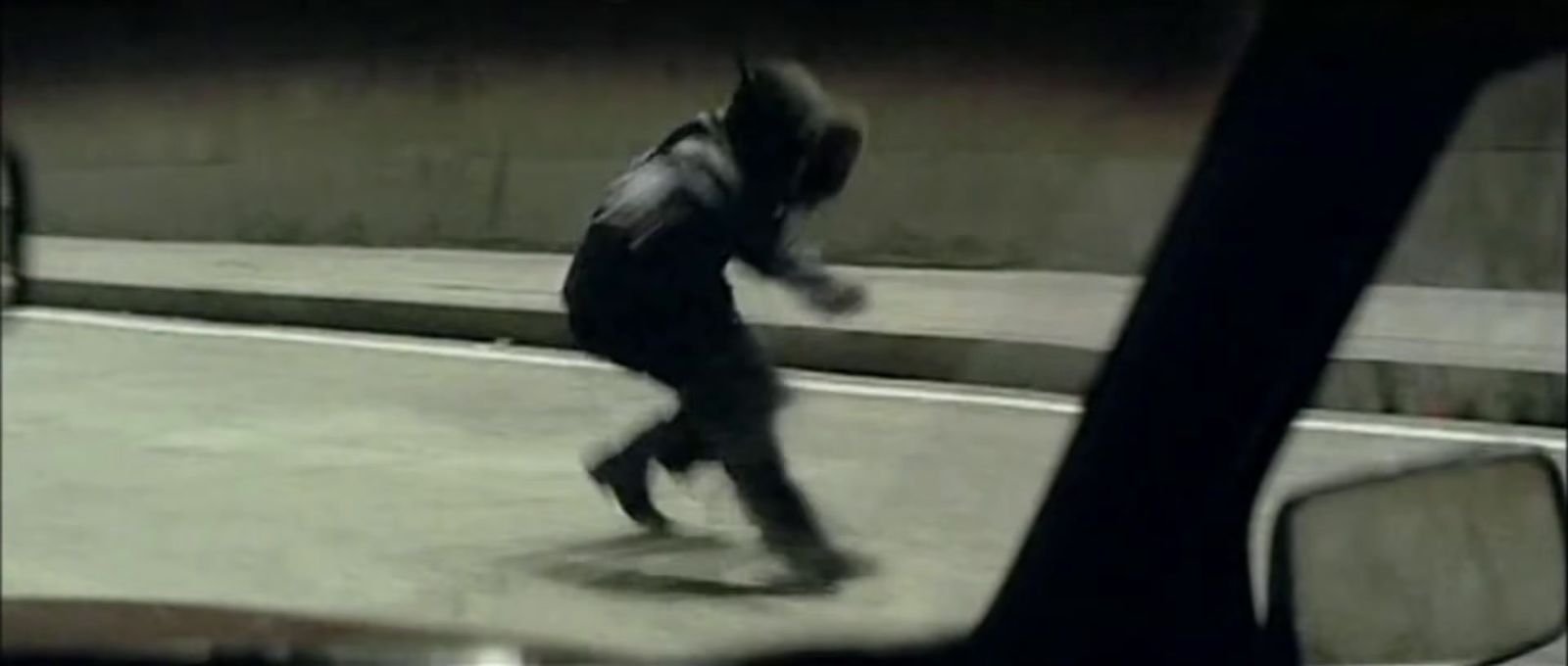 a man riding a skateboard down a street