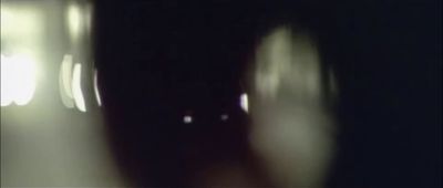 a blurry photo of a person's face in the dark