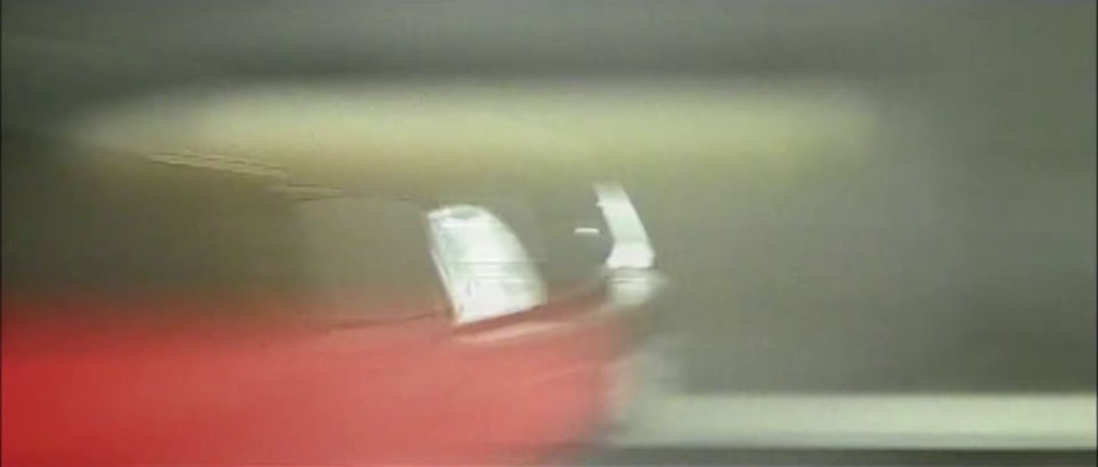 a blurry photo of a red and white airplane