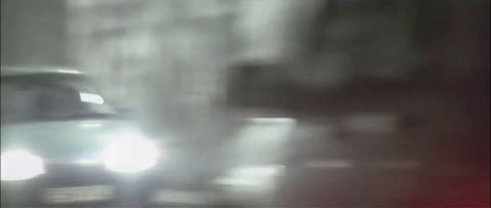 a blurry image of a car driving down a street