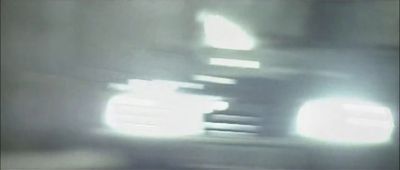 a blurry photo of a car driving down a road