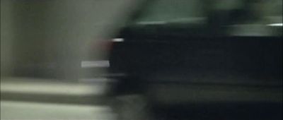 a blurry picture of a car driving down a street