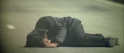 a man laying on the ground with his head down