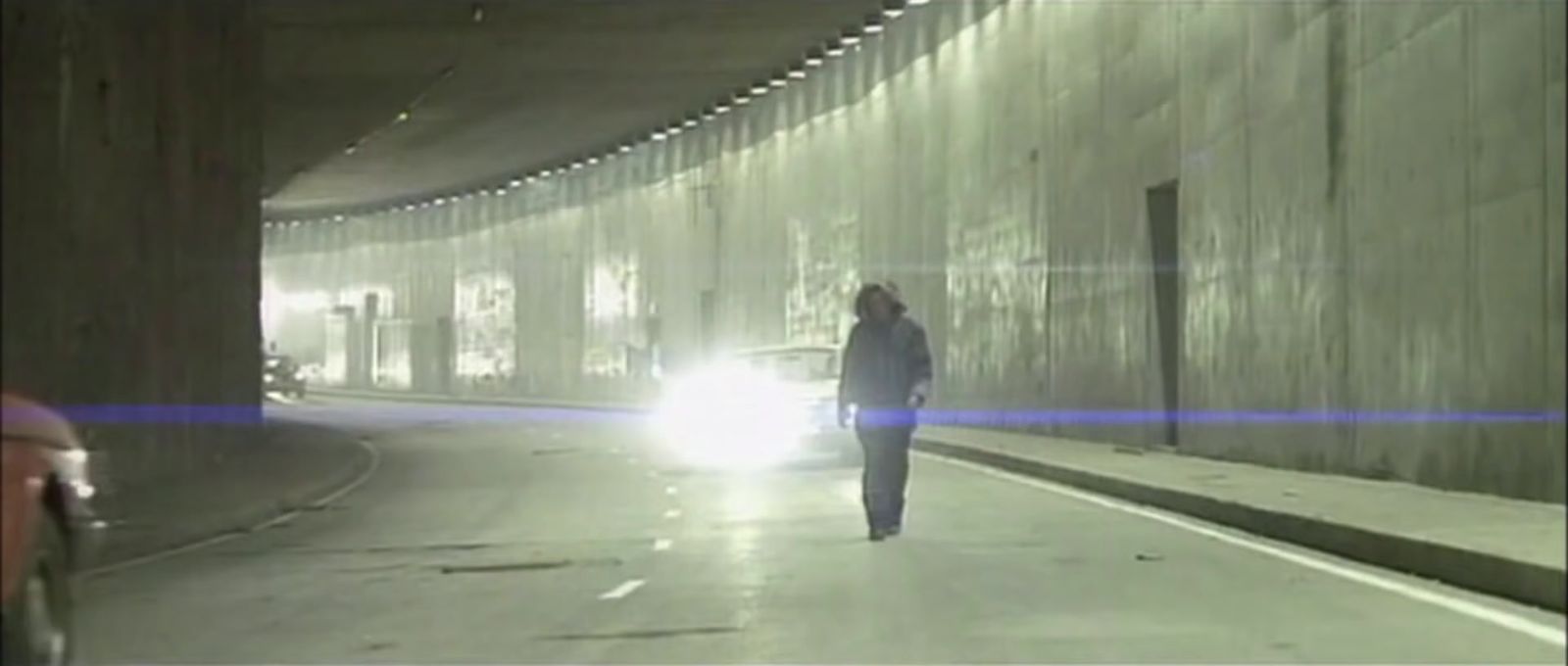 a person walking down a street at night