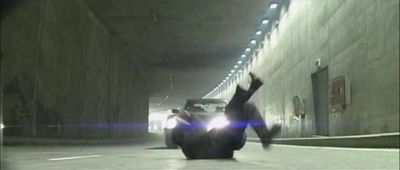 a person laying on the ground in the middle of a tunnel