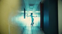 a woman standing in a hallway with her arms outstretched