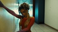 a woman in a red and gold outfit is dancing