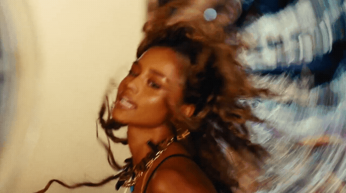 a woman with her hair blowing in the wind