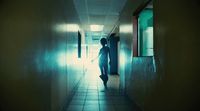 a person walking down a hallway in a building